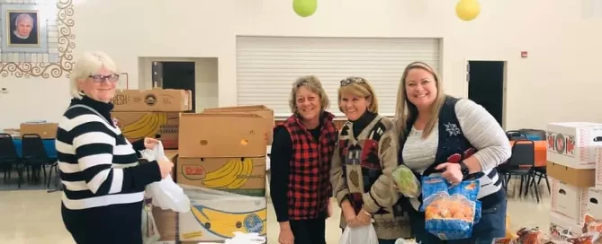 Volunteers pack food boxes with produce for the Fresh Food Initiative with Michigan Health Endowment Fund Grant